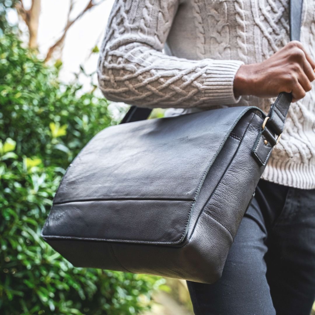The black leather messenger bag exudes professionalism and style