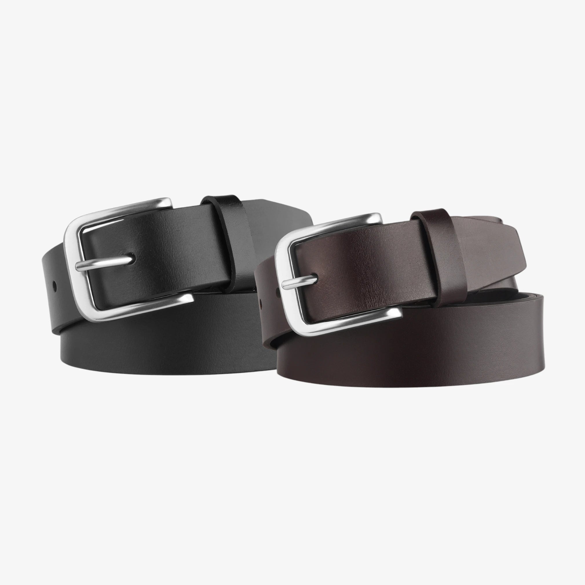 Two leather belts with silver buckles on a light gray background