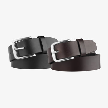 Two leather belts with silver buckles on a light gray background