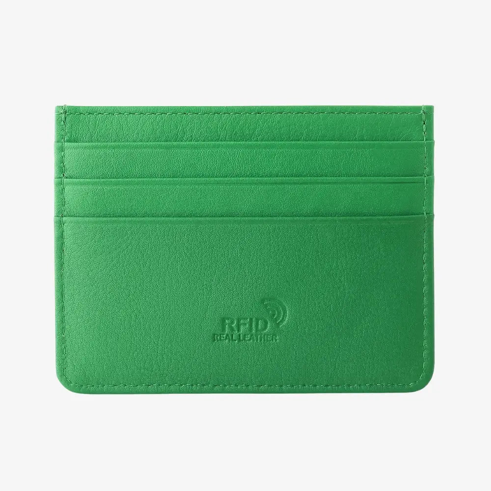Front view of green leather card holder on agrey background.