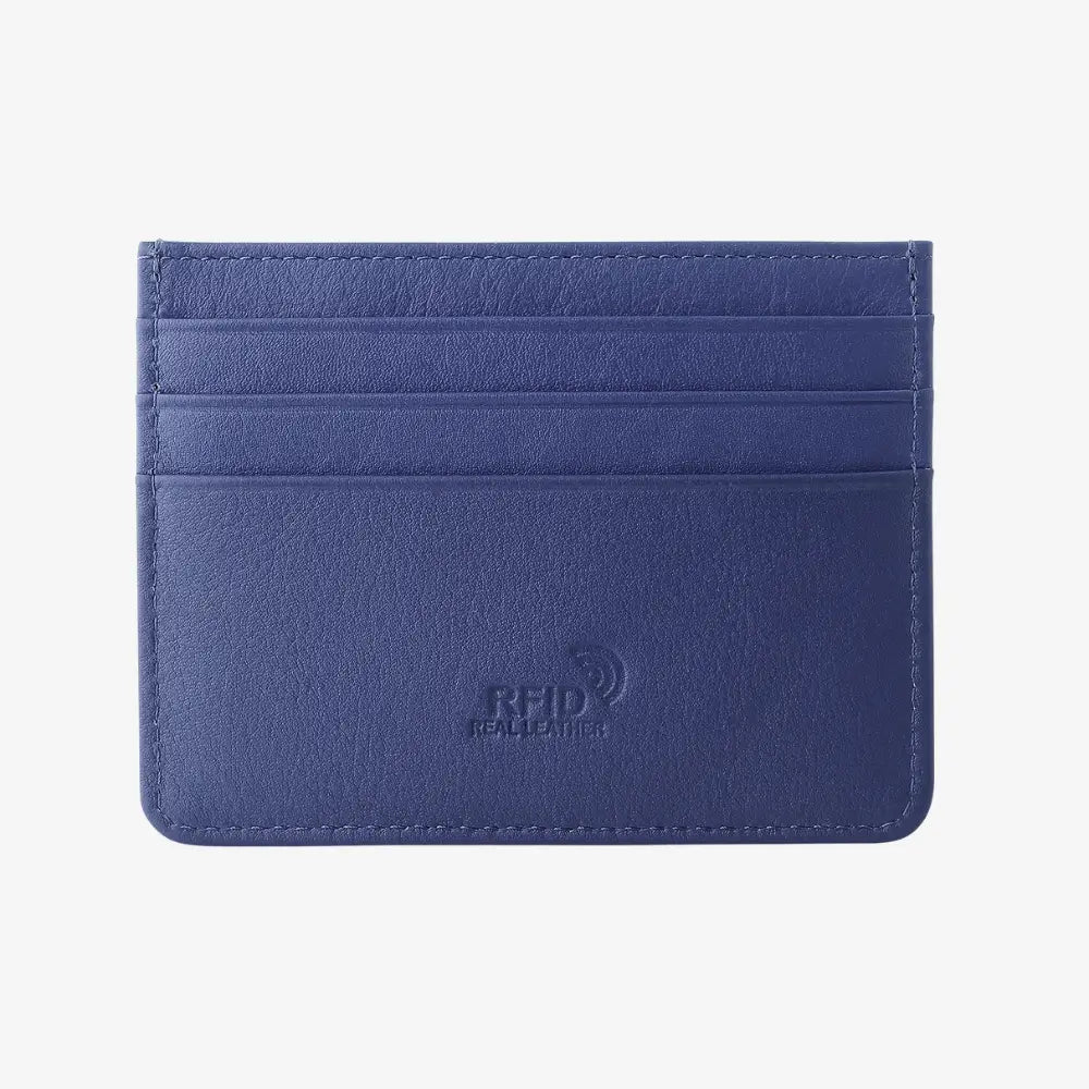 Front view of navy leather card holder on agrey background.