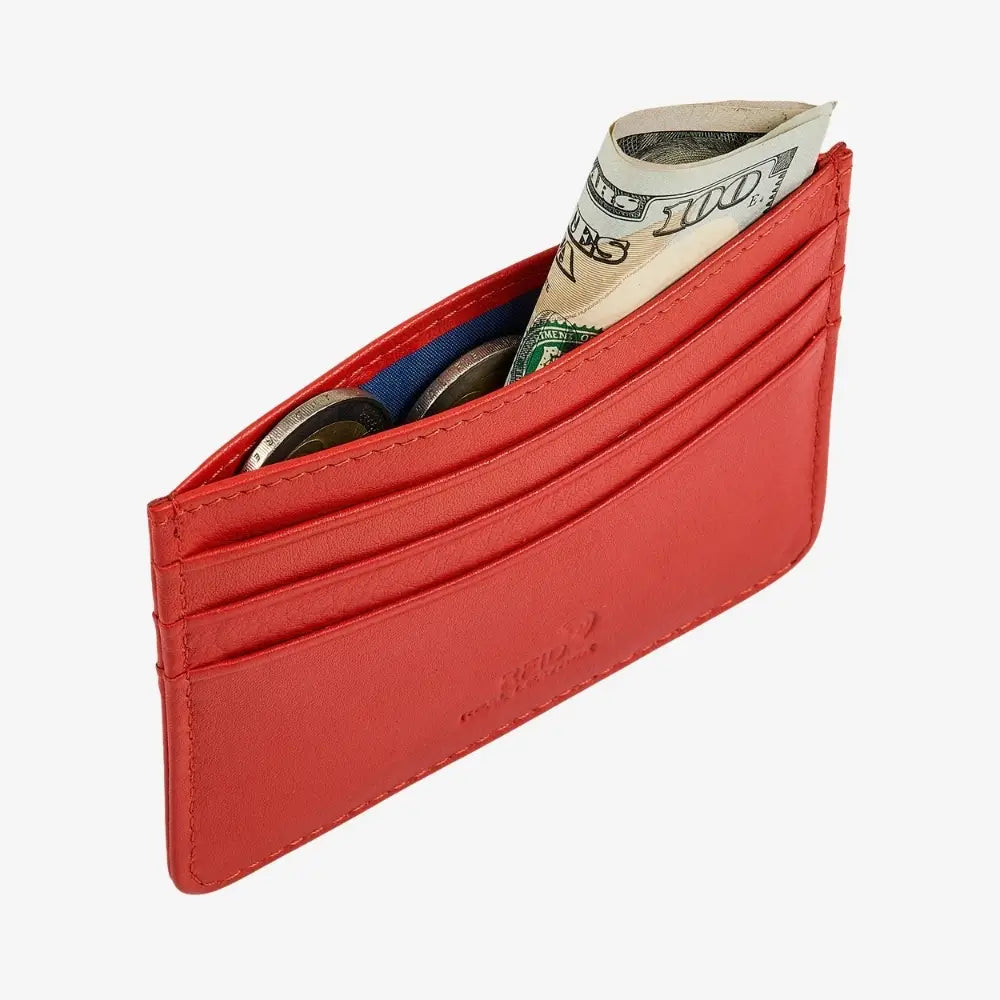 A orange leather cardholder wallet shown open, containing several credit cards and a rolled dollar bill, photographed on a clean white background.
