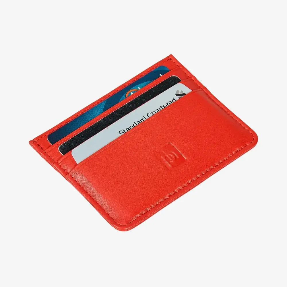 A orange leather cardholder wallet with three slots containing cards, shown on a light gray background.