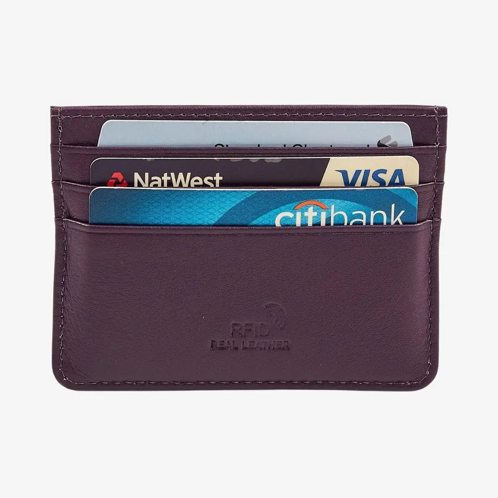 A purple RFID card holder wallet made of real leather, shown with four credit cards inserted. The wallet features a debossed logo on the front and is photographed on a clean, light gray background.