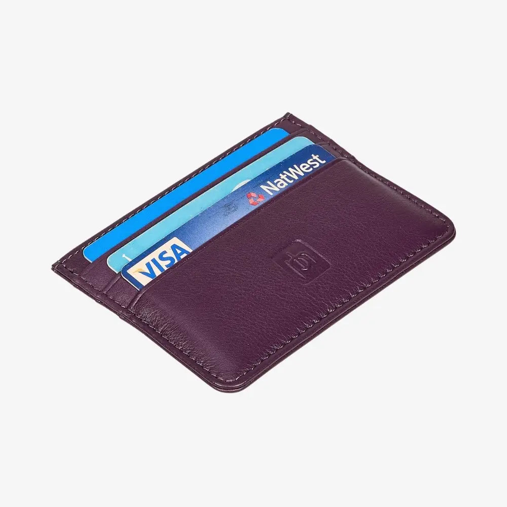 A purple leather cardholder wallet with three blue and light blue credit cards partially inserted, shown on a light gray background.