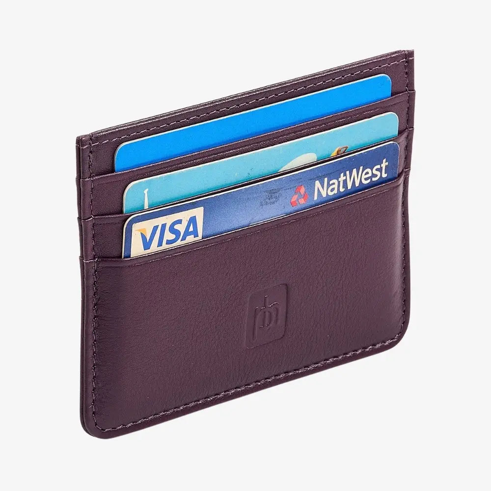 A purple leather cardholder wallet with four slots containing blue and light blue credit cards, including a visible NatWest card, on a light gray background.
