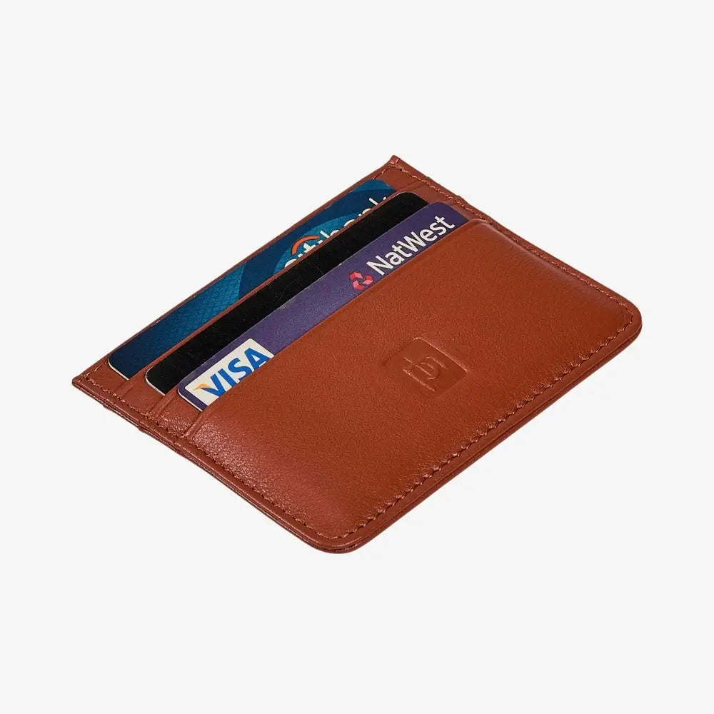 A tan leather cardholder wallet shown open, containing several credit cards including Visa and NatWest, on a light gray background.