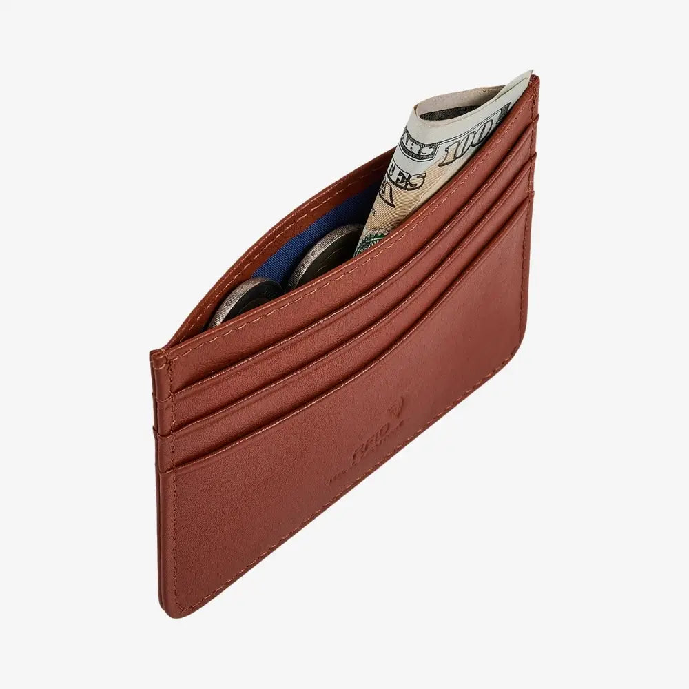 A tan leather cardholder wallet with multiple card slots, shown open with a rolled $100 bill and coins inside, on a light gray background.