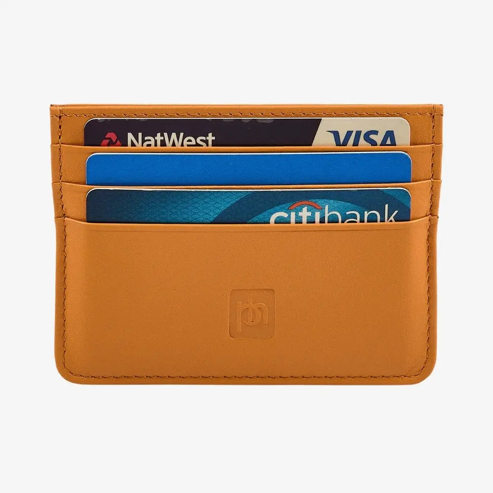 Front view of yellow leather card holder on agrey background.