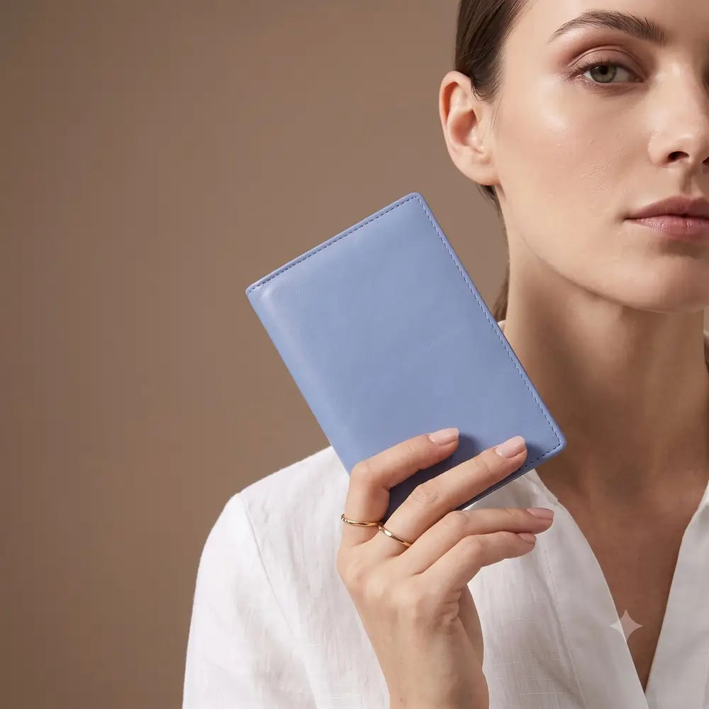 A light blue leather passport cover shown closed against a plain white background.