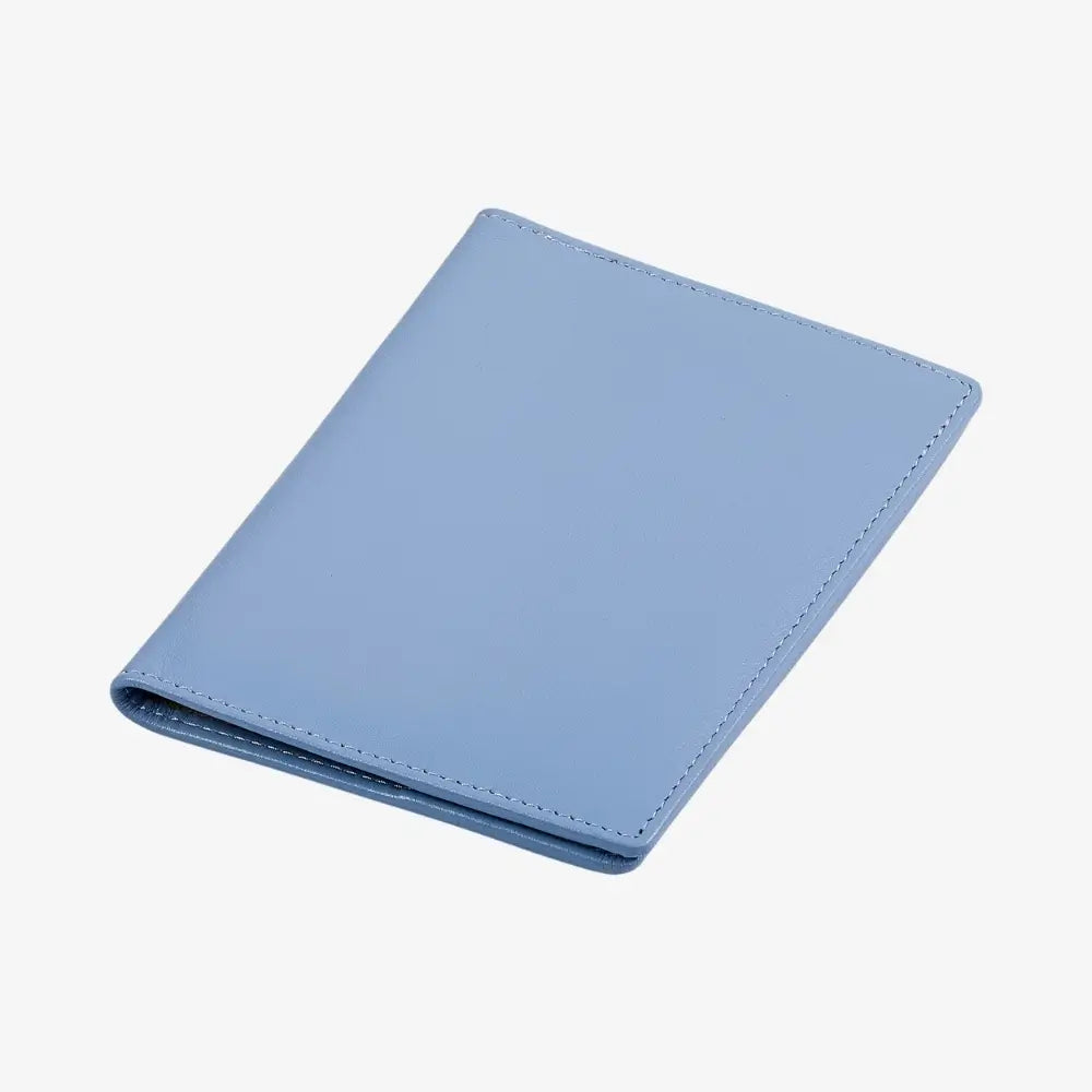 A light blue leather passport holder shown closed at an angle on a clean white background.