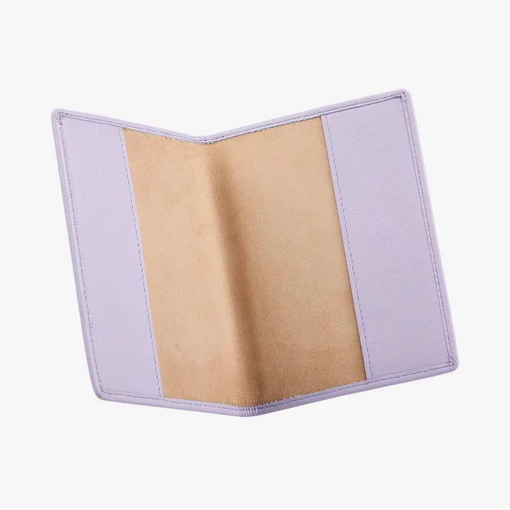 A lilac passport holder shown open, displaying a tan suede-like interior lining on a clean white background.