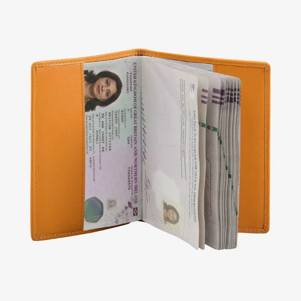 An open yellow leather passport holder containing an ID card and a stack of cash, shown against a plain white background.