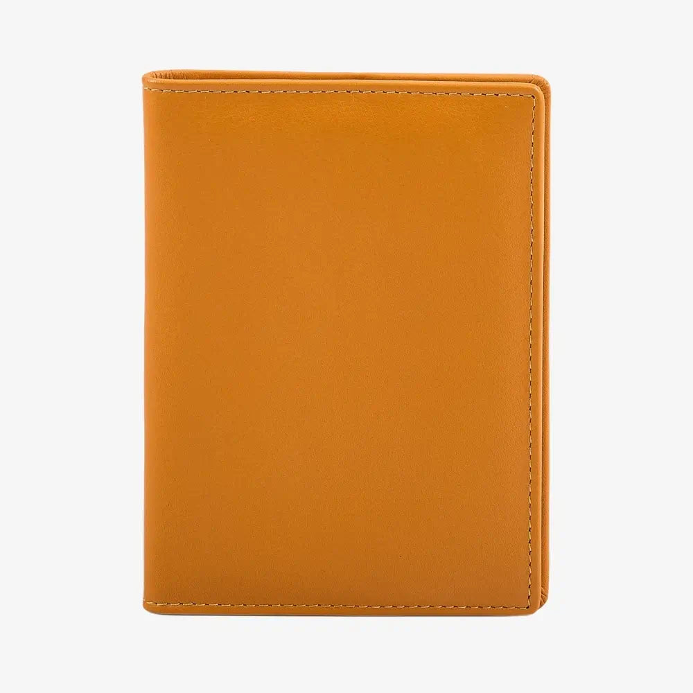 A yellow leather passport cover shown closed against a plain white background.