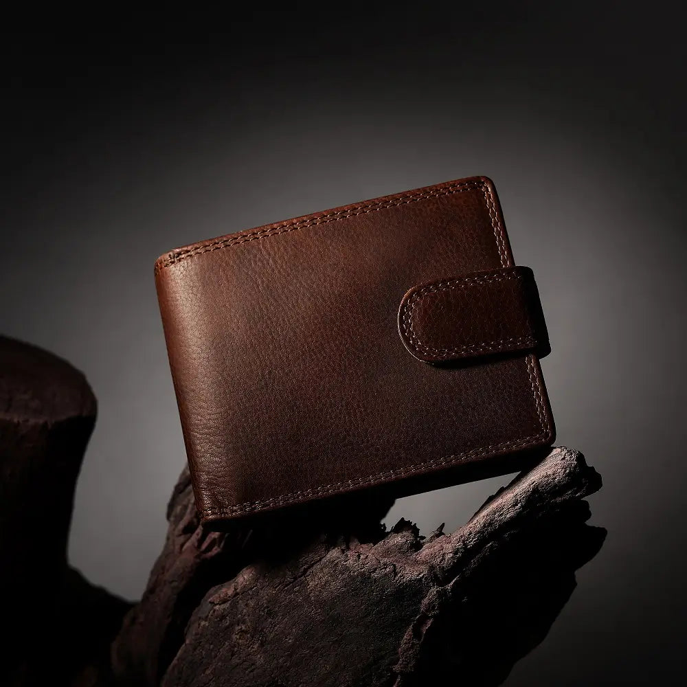 Brown leather wallet on a dark background