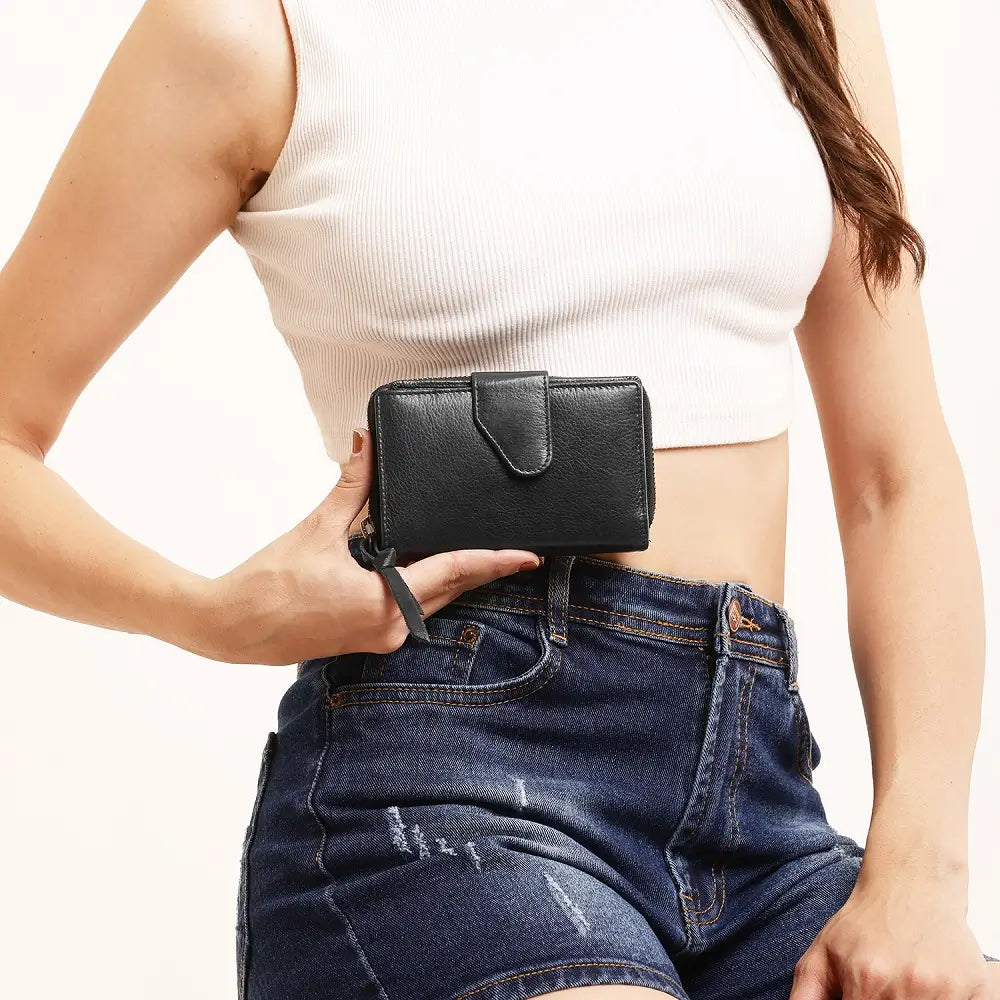 Black Renata bifold purse in washed Cancun leather held in hand