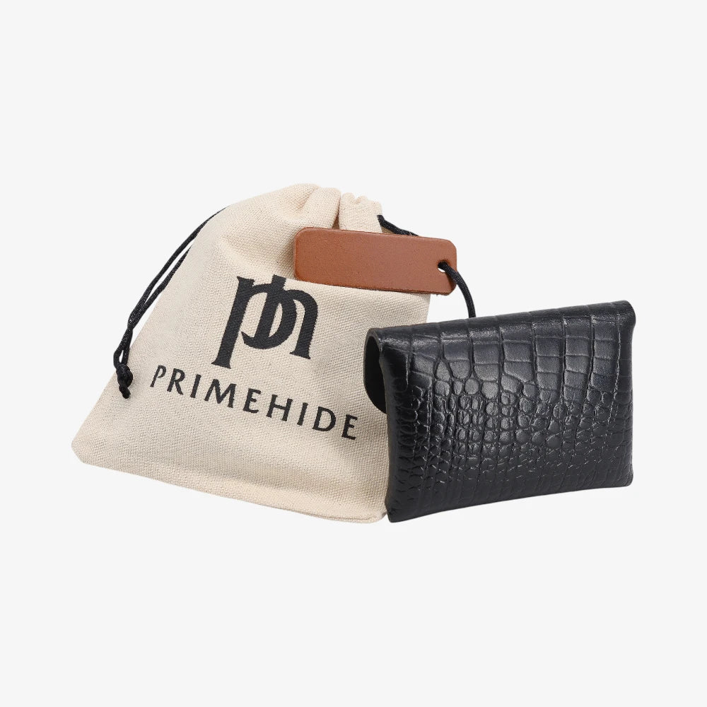 Back view of black croc print leather coin purse with textured finish next to branded pouch