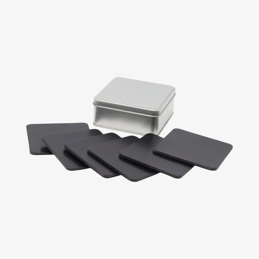 Full grain leather coaster set  of black square coasters with a silver storage box on a white background