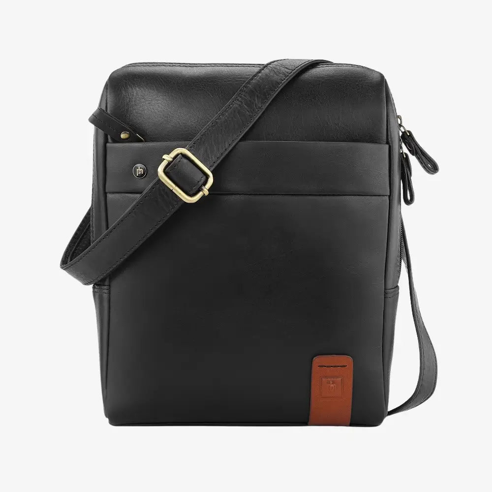Black leather messenger bag with a gold buckle on a white background