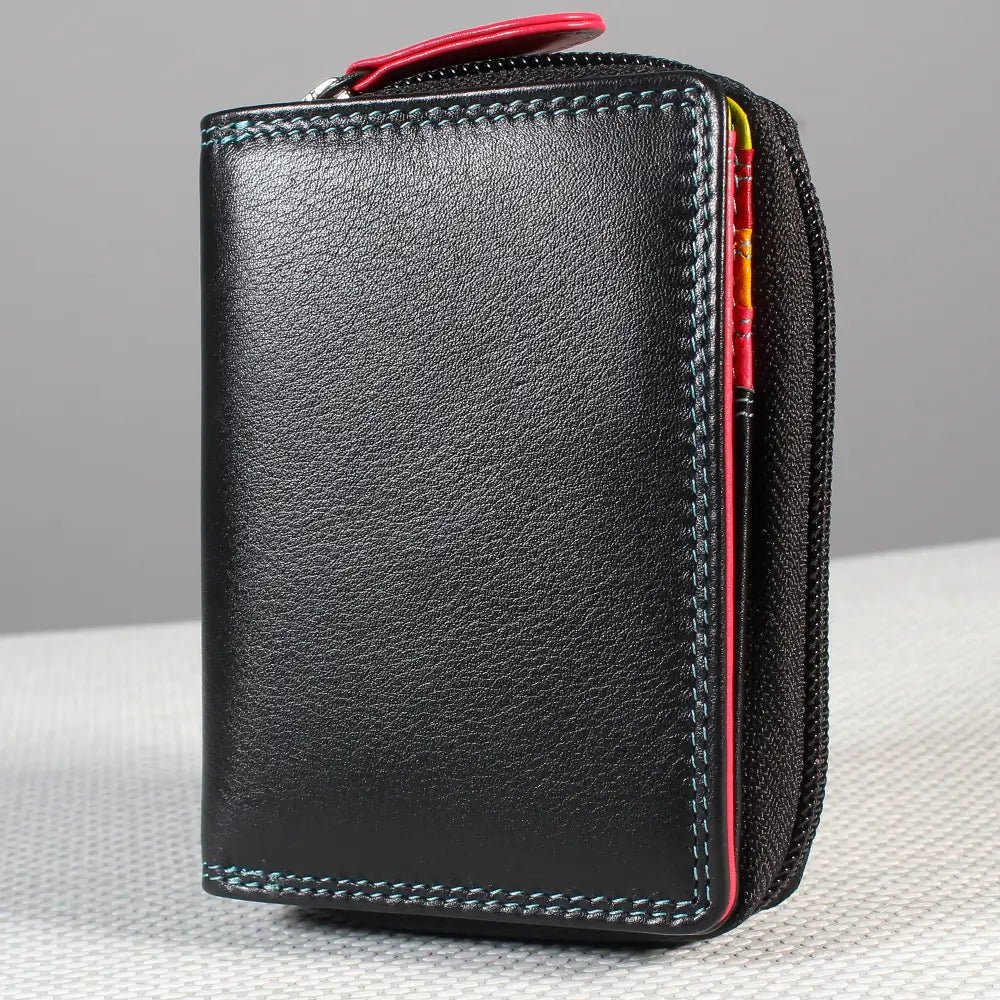 Black leather wallet with colorful zipper pull on a gray background