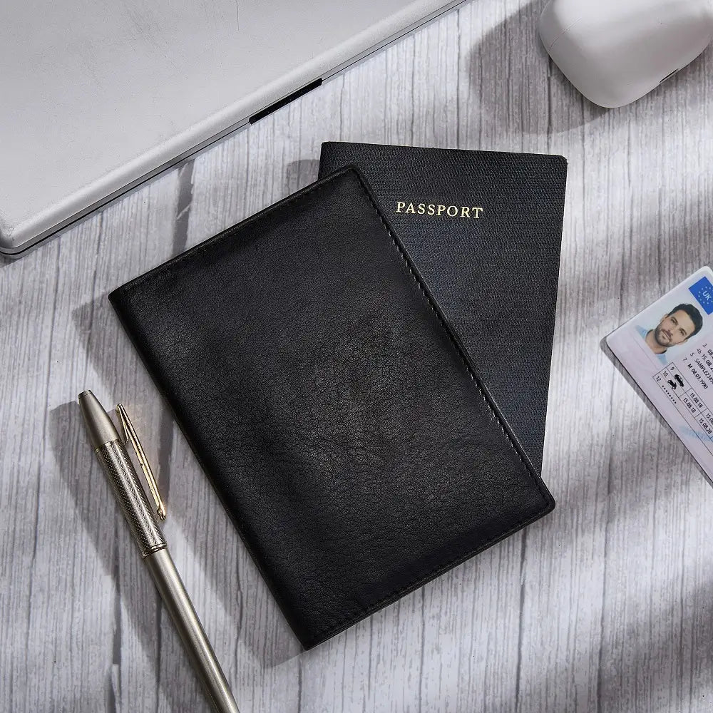 Black passport holder with a passport and ID card on a wooden surface.
