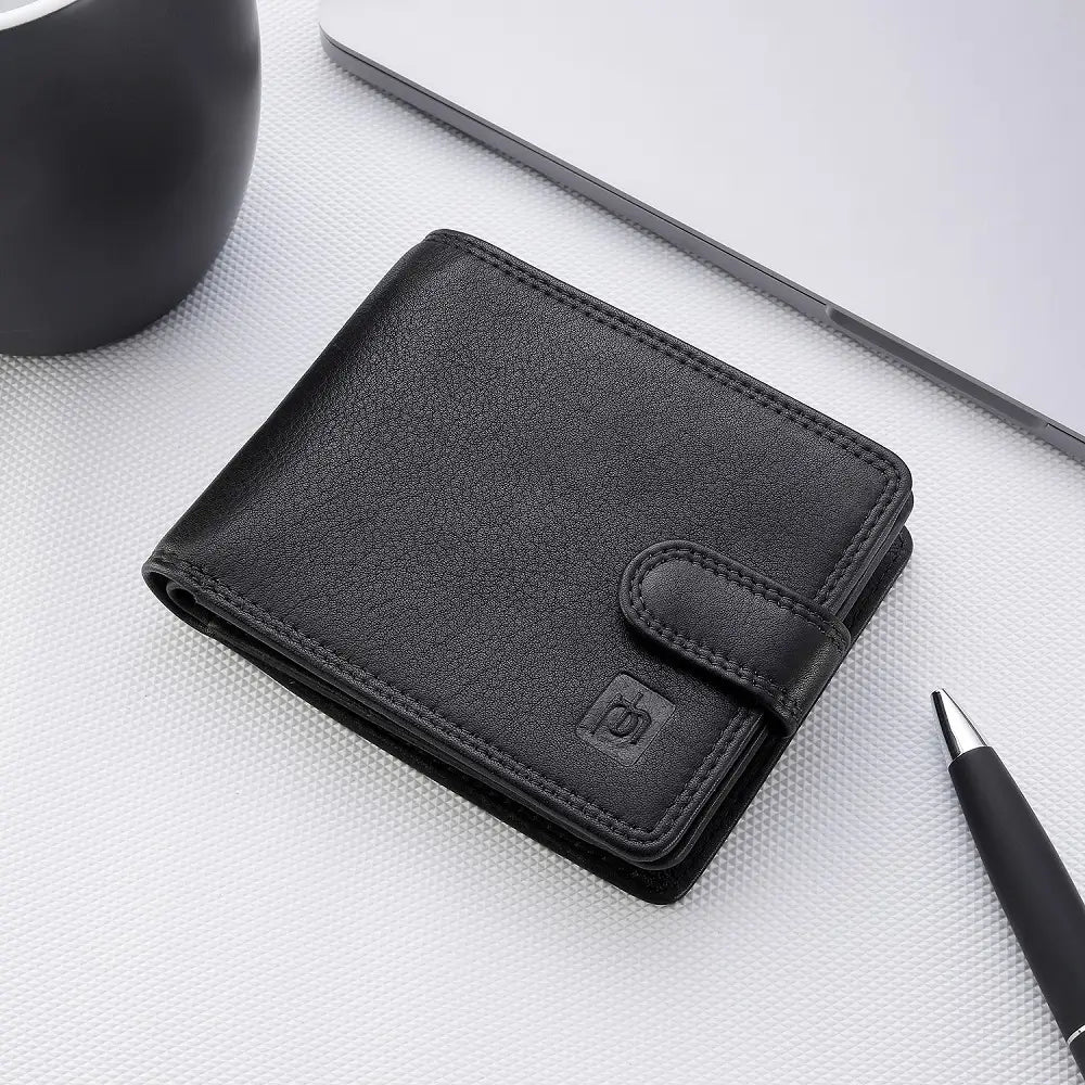 Black leather wallet on a light gray surface with a pen and phone in the background