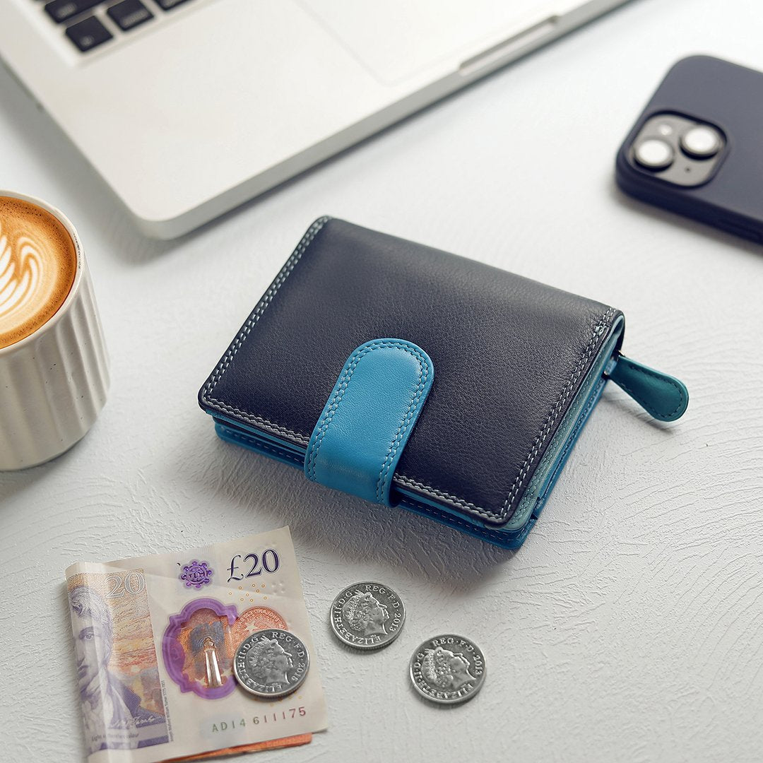 Blue leather purse placed with daily essentials for a lifestyle view