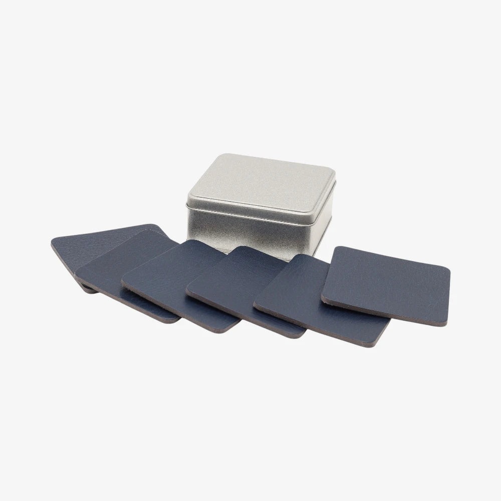 Set of blue coasters with a silver storage box on a white background