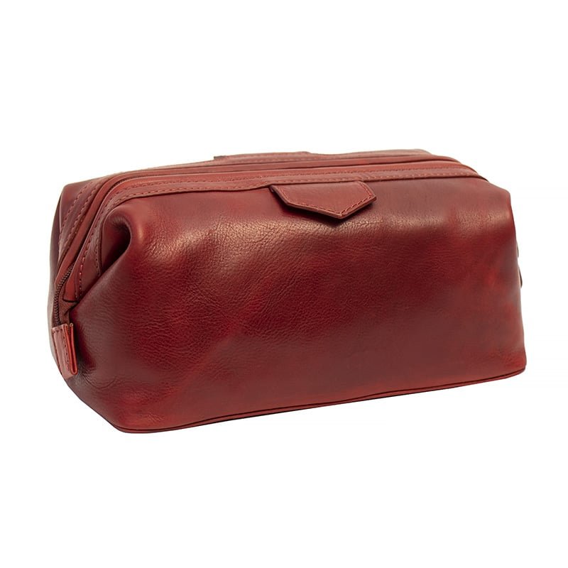 Black toiletry bag on a marble bathroom counter with a sink and mirror in the background.