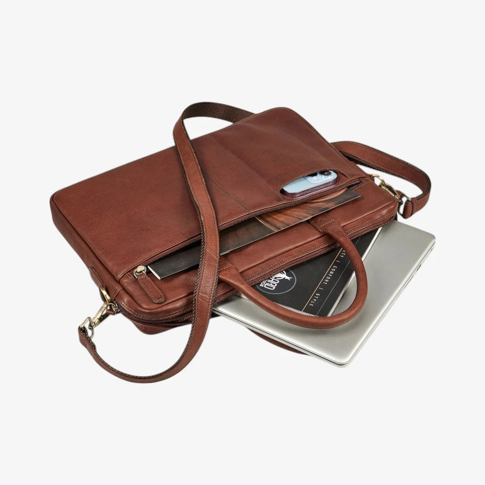 Brown leather briefcase with a laptop on a white background