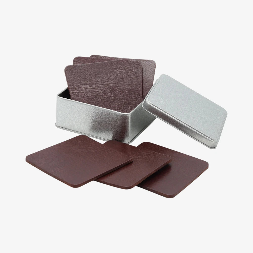 Set of brown coasters with a silver holder on a white background
