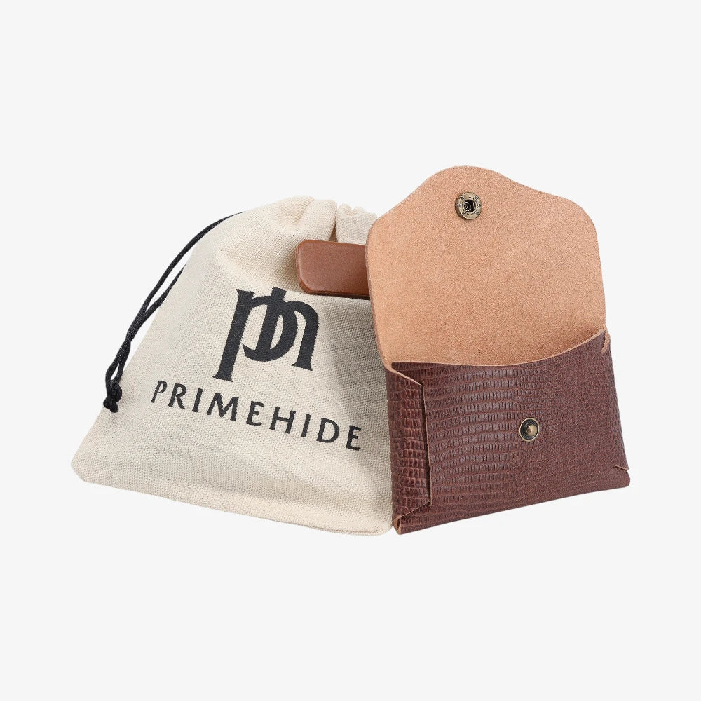 Brown snake print leather coin purse with flap closed displayed beside Primehide dust bag