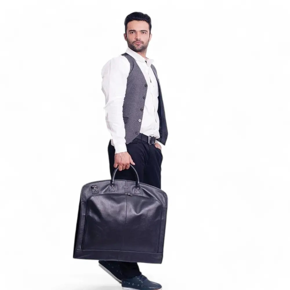 Man holding a large brown garment bag against a white background
