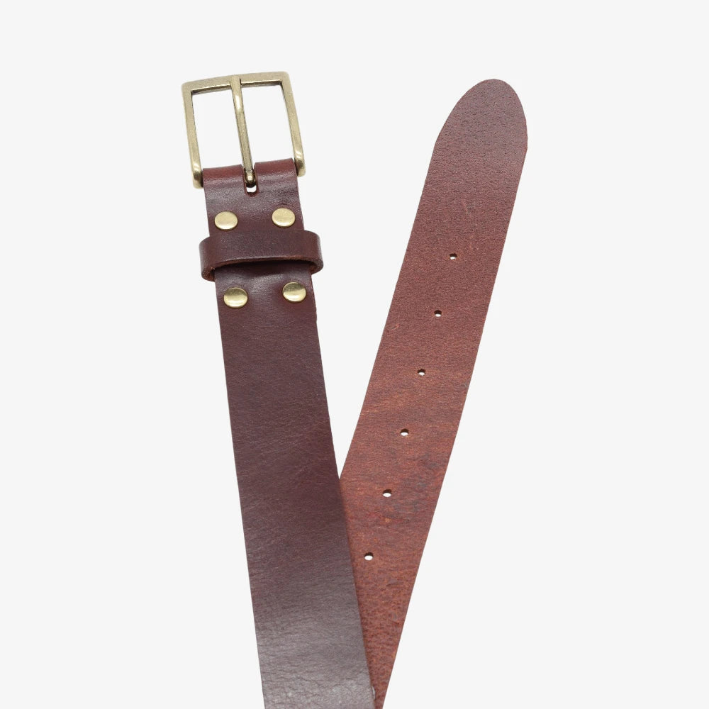 Top angle view of Brown leather belt with brass buckle on a white background