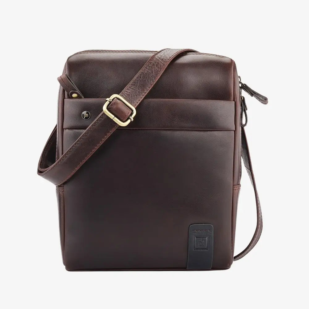 Brown leather messenger bag with a strap on a white background