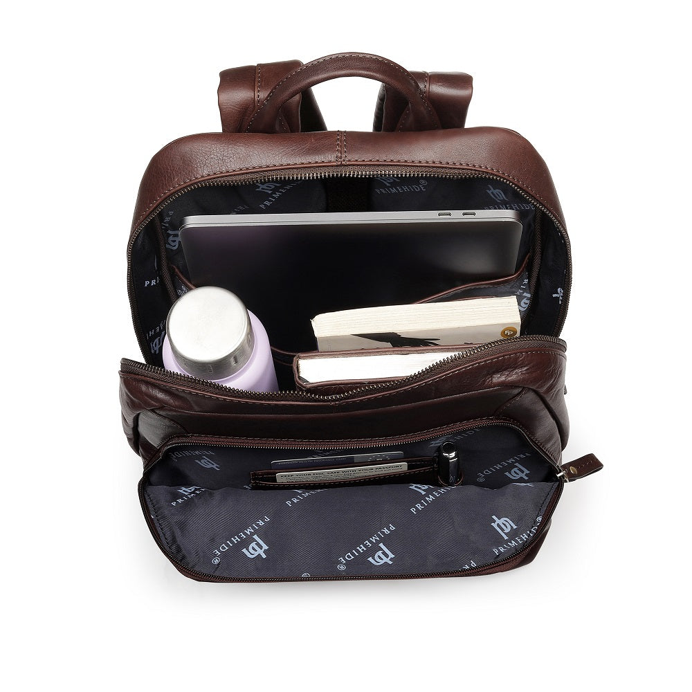 Brown leather backpack with items inside on a white background