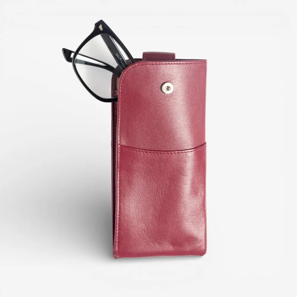 Burgundy leather case with a pair of glasses on a white background