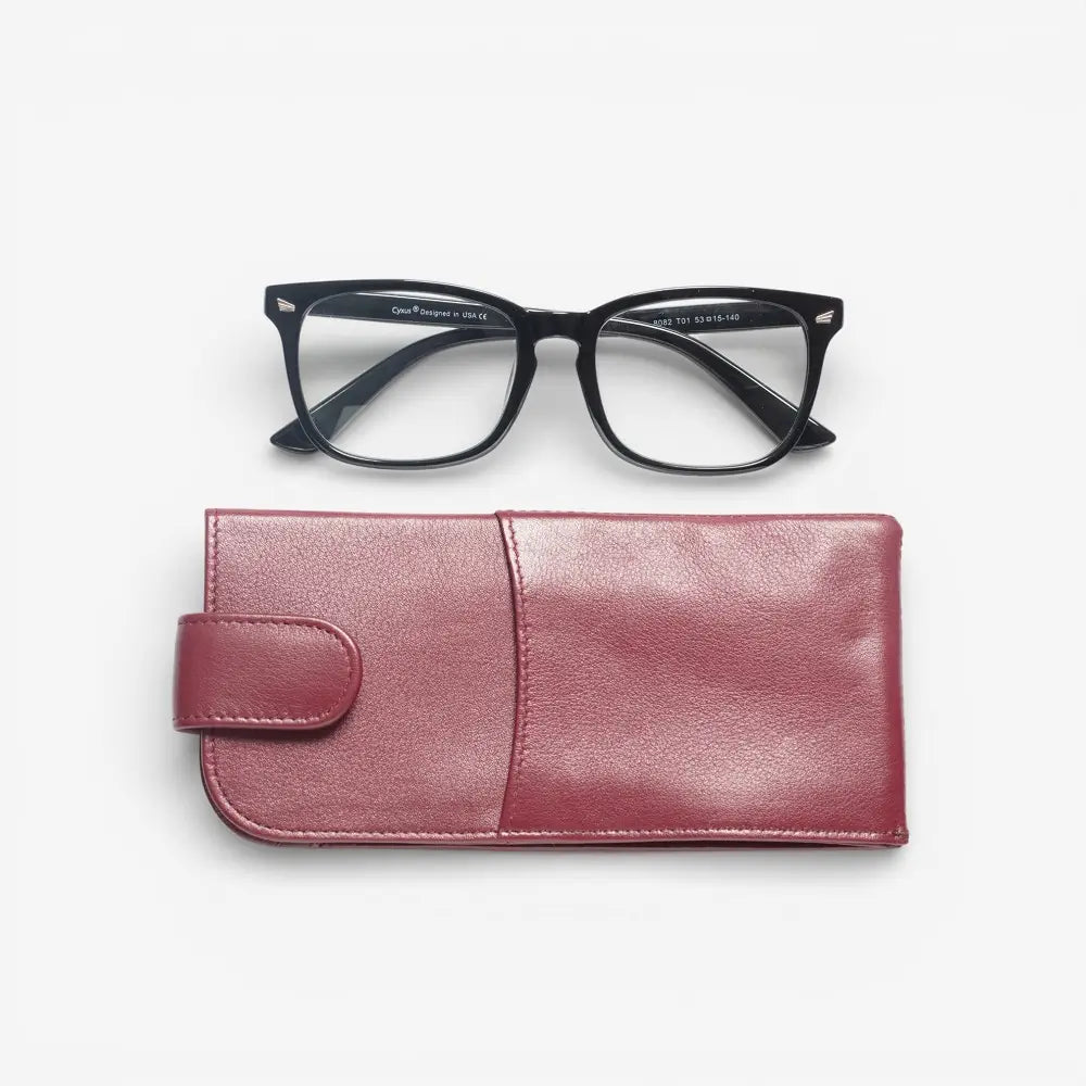 Black-framed glasses on a Burgundy eyeglass case against a white background