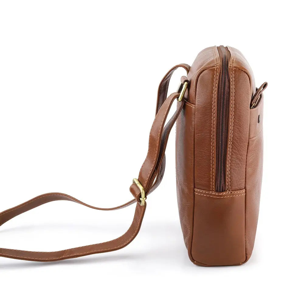 Tan leather messenger bag on a white background