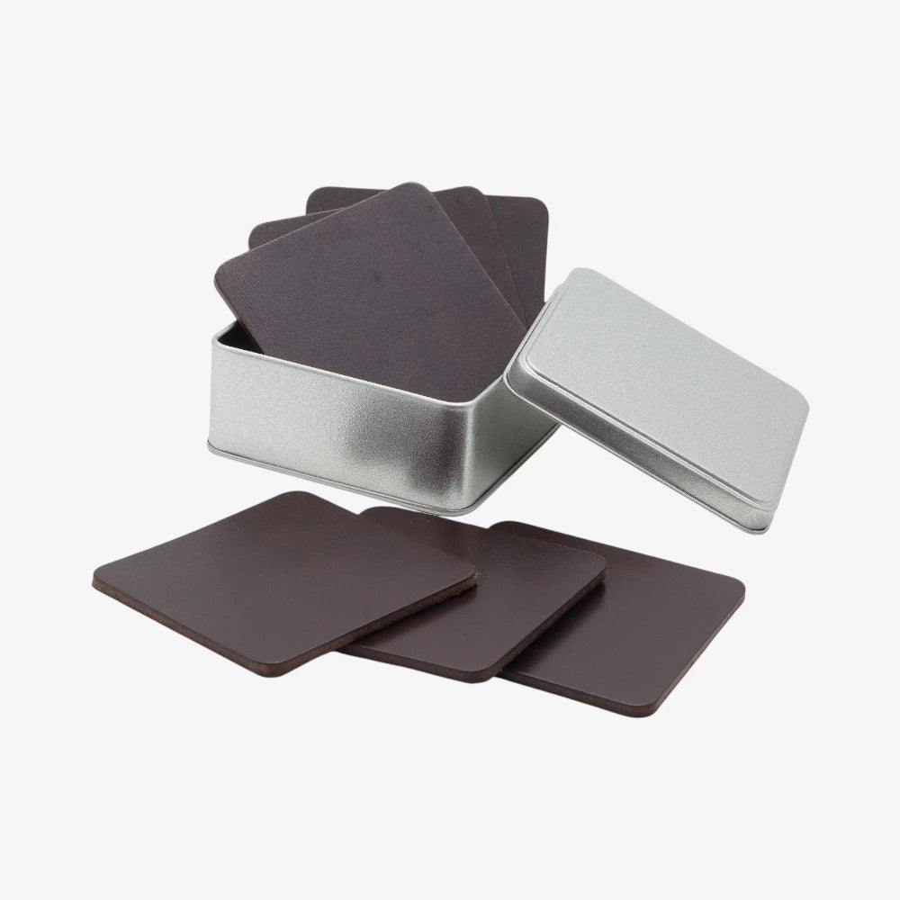 Set of chocolate coasters with a silver storage tin on a white background