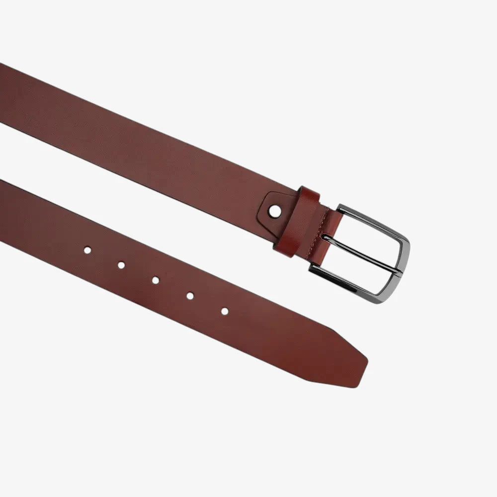Top angle view  of Cognac leather belt with a silver buckle on a white background 
