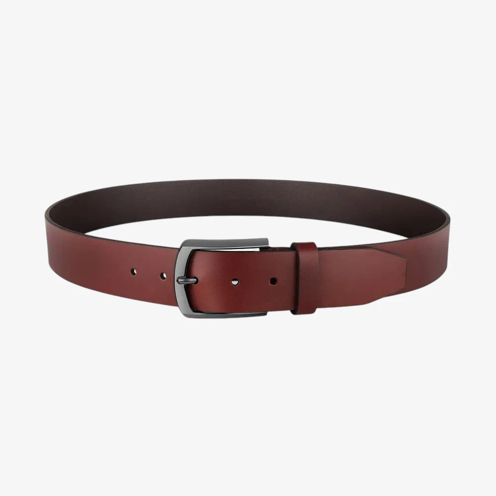 Full length view of Cognac leather belt with a silver buckle on a white background
