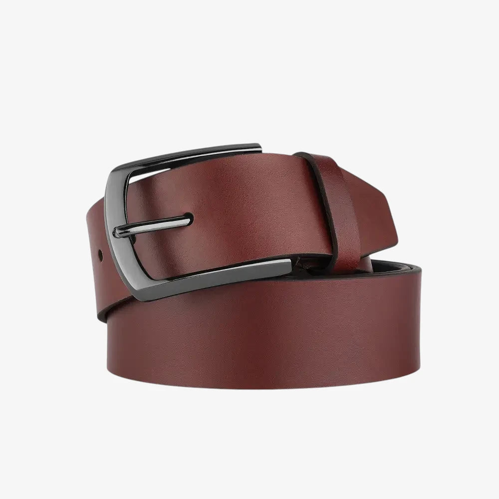 Cognac leather belt with a silver buckle on a light gray background