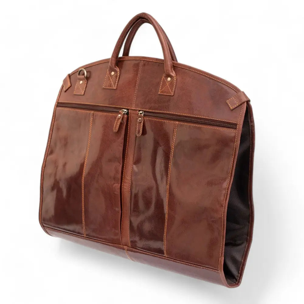 Cognac leather garment carrier with zippers on a white background