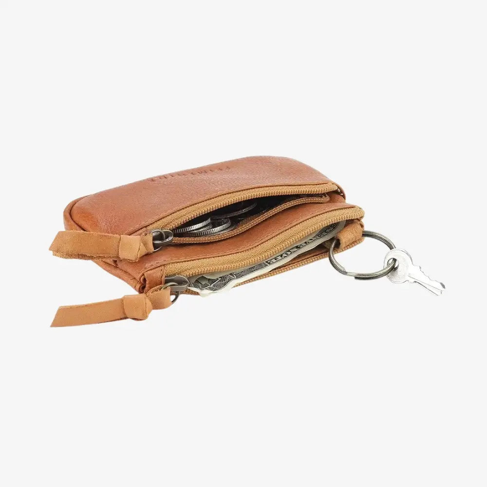 Cognac leather keychain pouch with a key attached on a white background