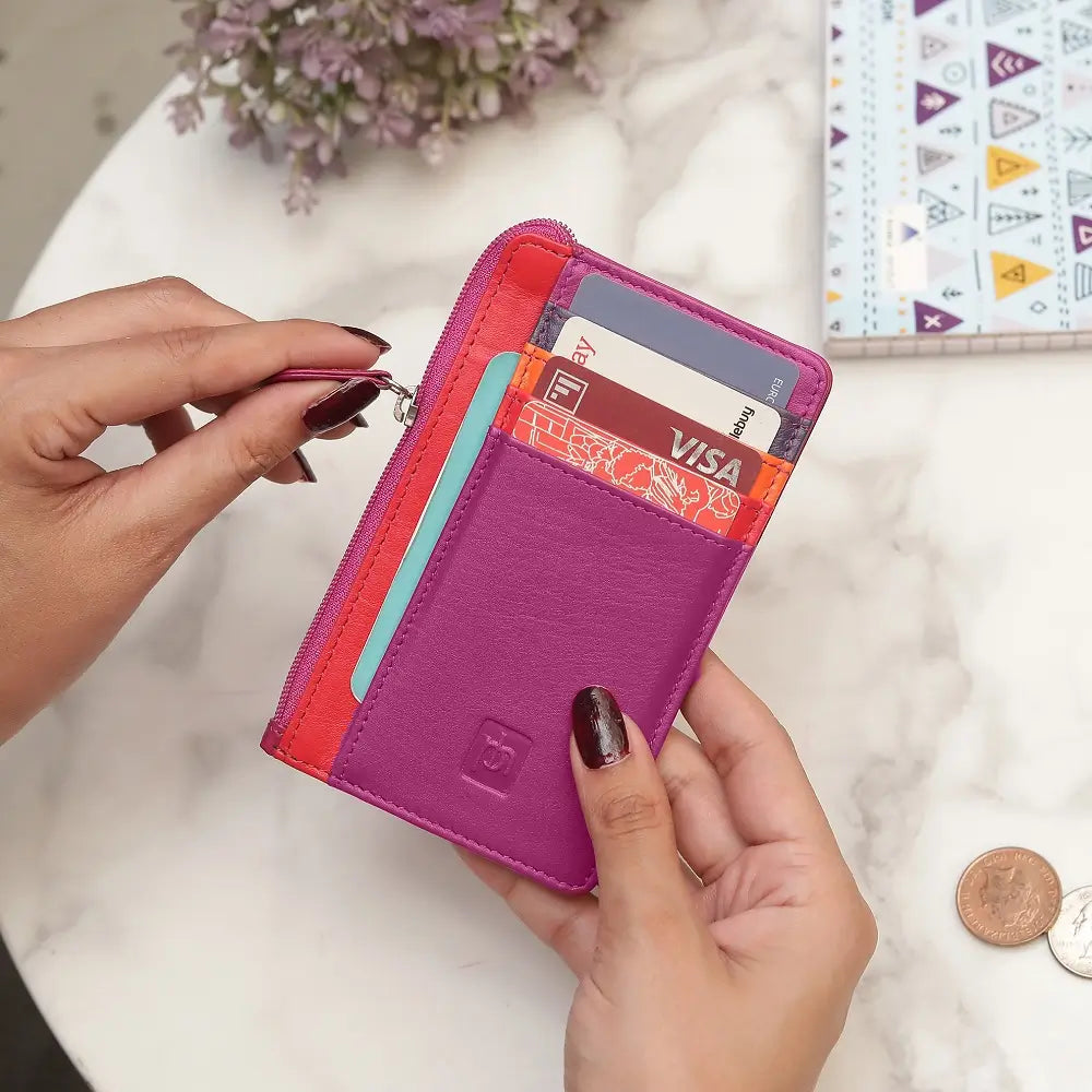 Fuchsia Card Holder Purse with card slots held by hands on a light background
