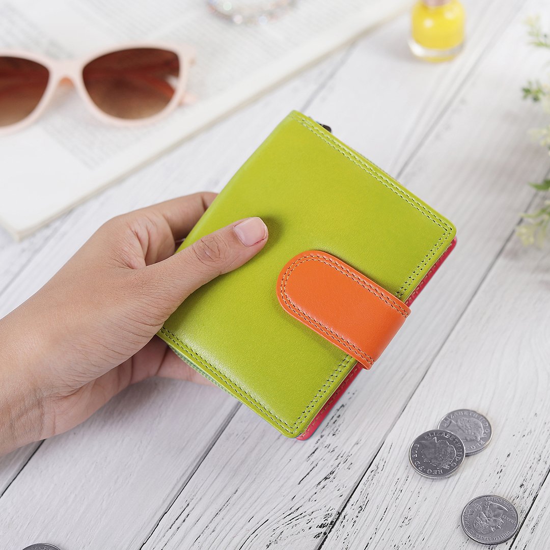 Green leather purse placed with daily essentials for a lifestyle view