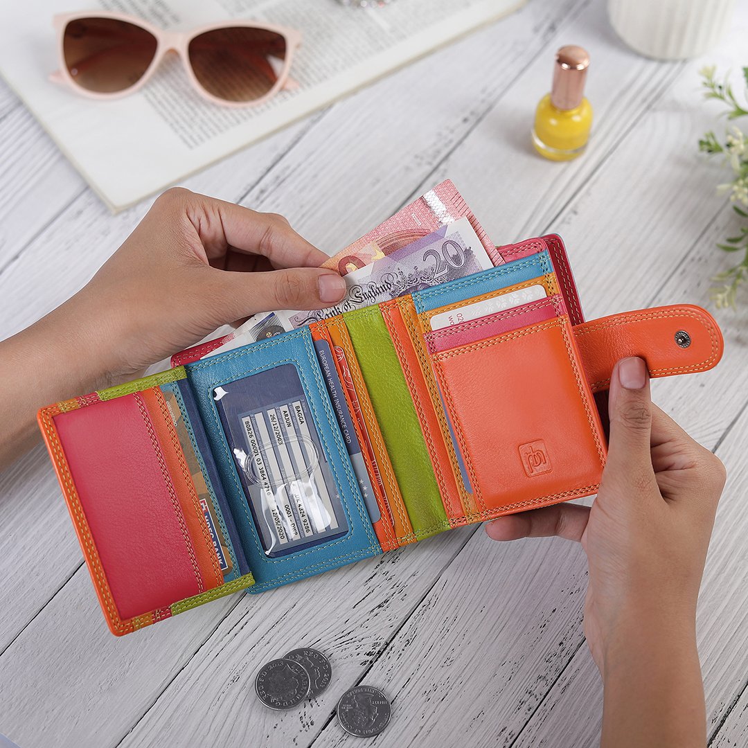 Green leather purse placed with daily essentials for a lifestyle view