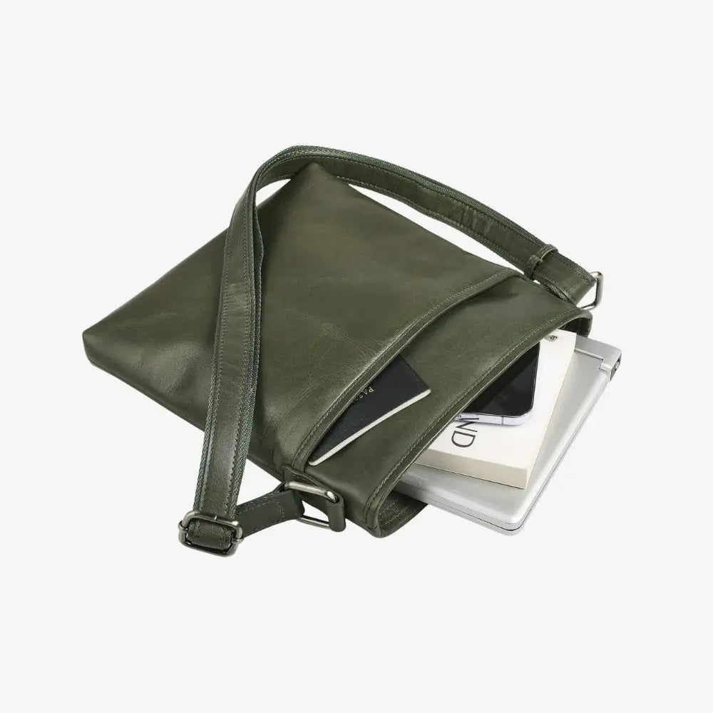 Green leather crossbody bag with a strap on a white background