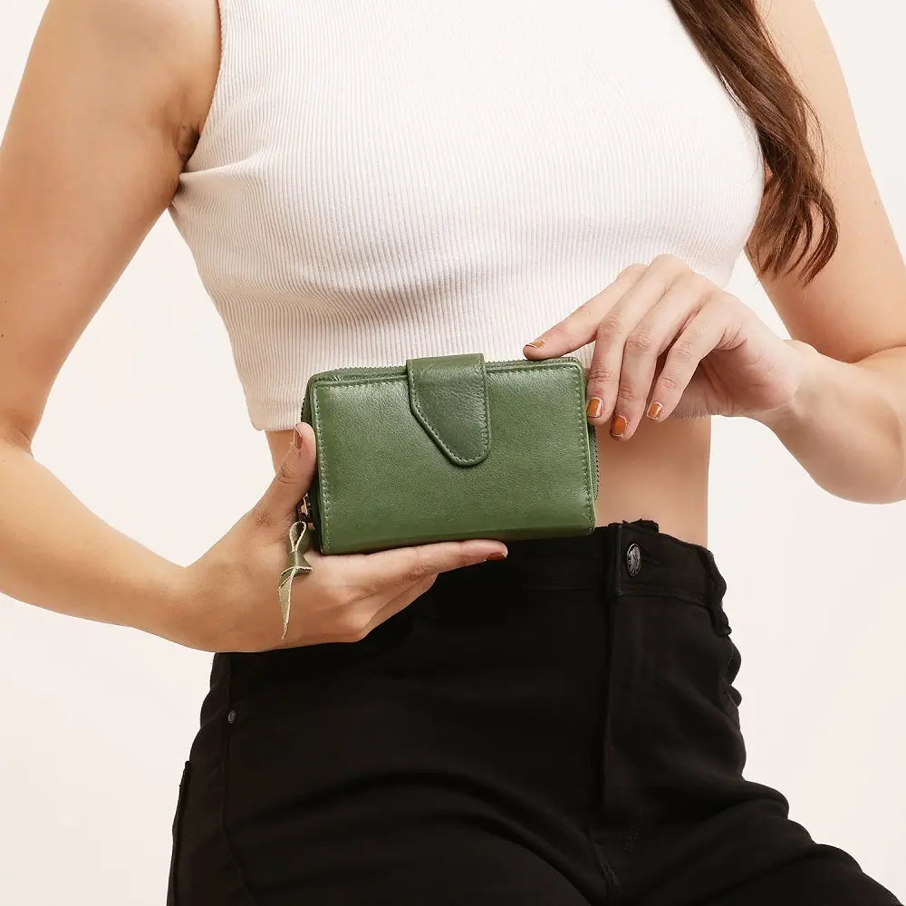 Green Renata bifold purse in washed Cancun leather held in hand